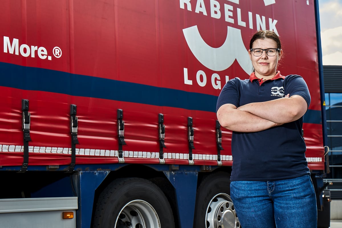 Rabelink Logistics employee standing in front of a truck