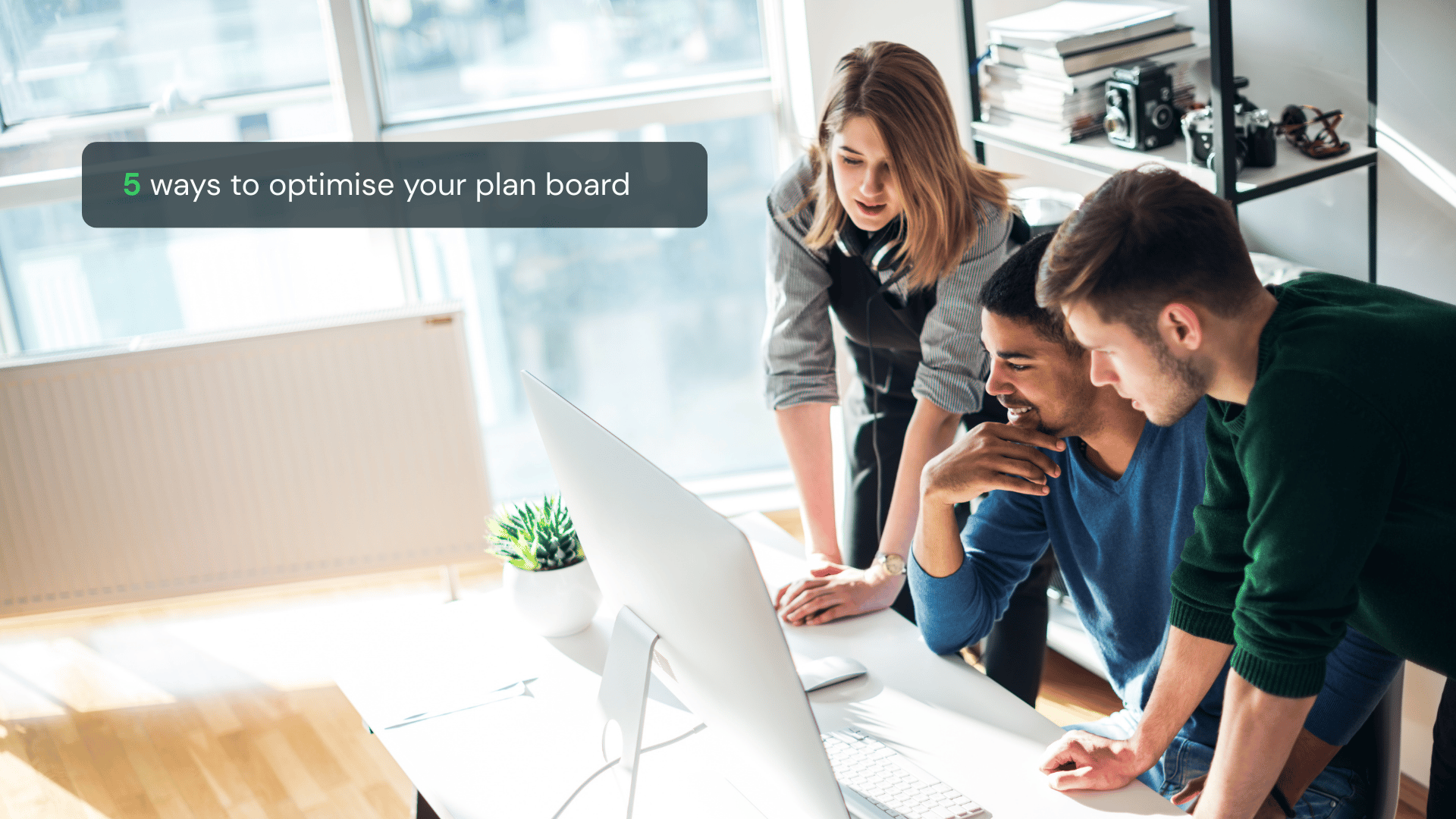 Three colleagues looking at a planning board