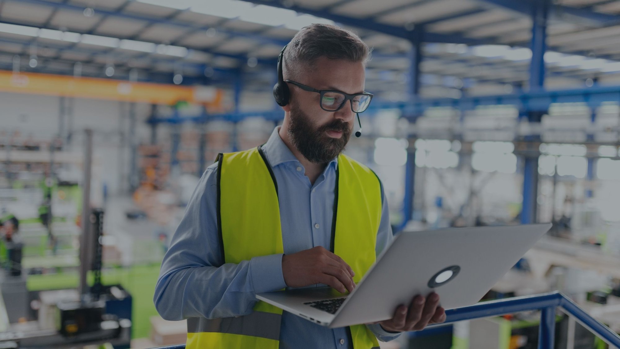 Warehouse worker with a laptop and a headset