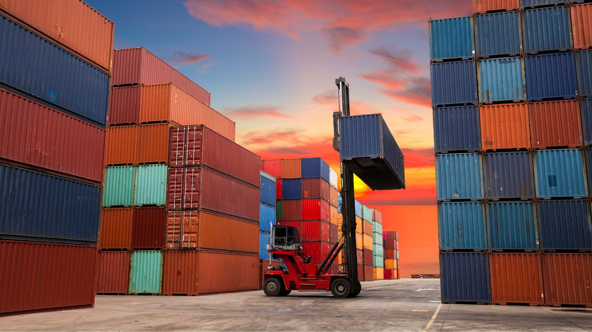 Forklift lifting a container in a container yard