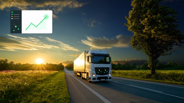 Truck on a motorway at sunset with an analytics chart overlay