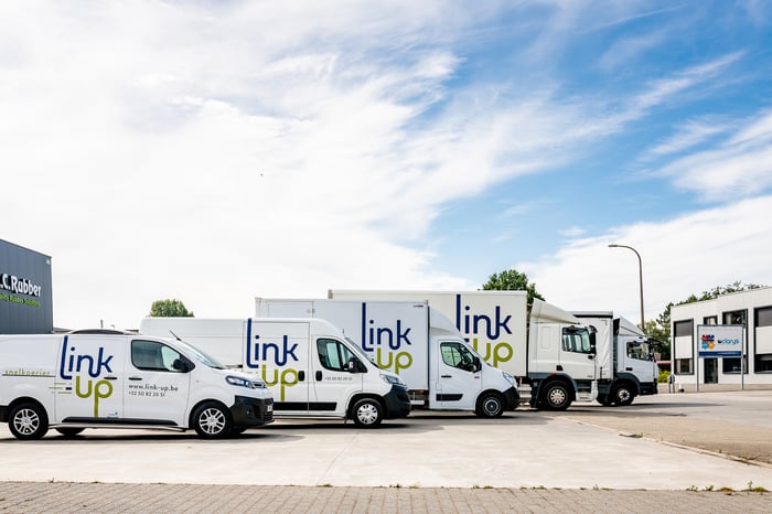 Link-Up vans and trucks in front of the office